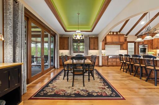 Dining room with custom cabinetry and tray ceiling with lighting