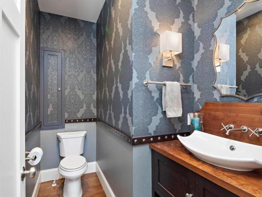 Main floor Powder Room. Opposite the staircase. Don't miss the built in cabinetry above the loo. 244 Broadway Ave N Wayzata MN 55391