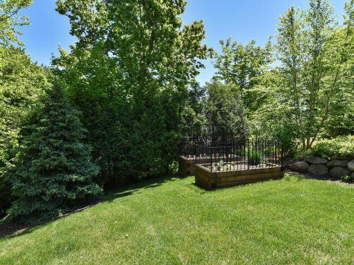 Private / tranquil setting in the heart of Wayzata! Raised gardens mark the SE corner of the estate. The eastern border is lined with year round privacy arborvitae and elevates well above the neighboring estate. 244 Broadway Ave N Wayzata MN 55391