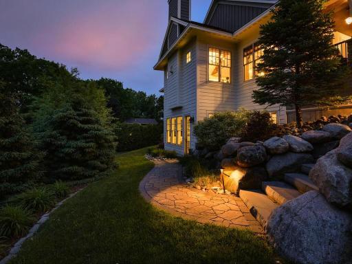 All pathways and patios are accented by copper down lit fixtures and automated by photocells and timer. 244 Broadway Ave N Wayzata MN 55391