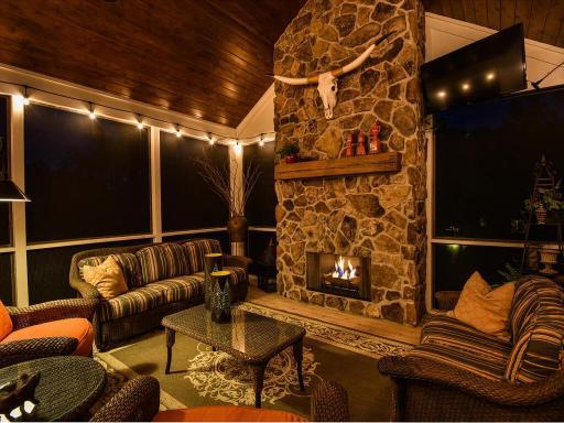 Custom built floor to ceiling gas fireplace anchors your vaulted screened porch. How awesome is this! Imagine the banter back and forth from here down to the fire pit. There is a landing for the grill and stairs to patio. 244 Broadway Ave N Wayzata
