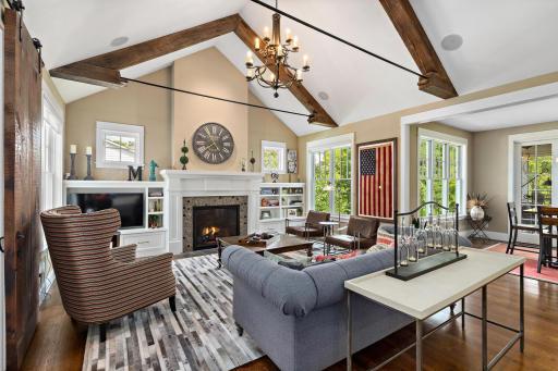 Main floor living room presents soaring 20’ vault with reclaimed custom hand hewn beam accents 244 Broadway Ave N Wayzata MN 55391