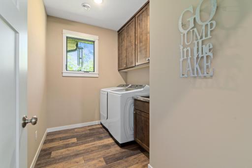 Main floor laundry room has natural lighting and additional storage.