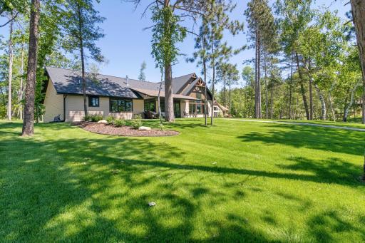 Tall pines greet you as you step out to the back yard. You will enjoy some sun and shade while playing yard games and entertaining near the waterâs edge.