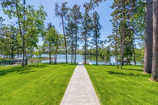 Concrete walkway that leads to easy access to the lake .