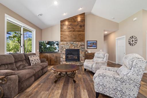 Luxury vinyl flooring and floor to ceiling fireplaces are great features of this great room and is open to the kitchen and dining room.