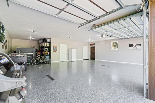 Heated garage with a mechanical room and drain tiles that lead to access to the home.