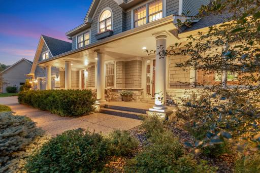 Cozy covered porch with pillars and aggregate walk and patio.
