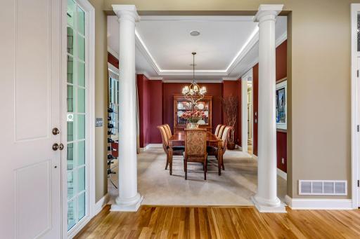 Large formal dining room where the sophisticated design includes dual pillar accents.