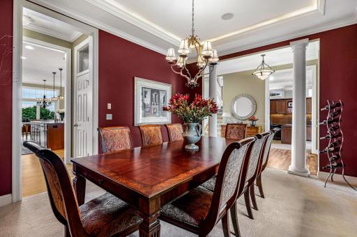 Lovely tray vaulted ceiling with up-lighting, crown molding, and convenient kitchen access.