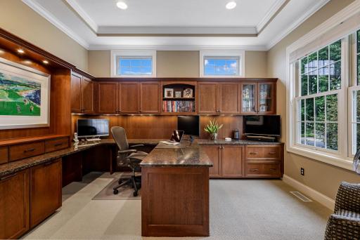 Off the foyer is the incredible home office featuring custom cherry built-ins, a granite work surface and thoughtful storage options. Wire management system keeps it looking clean and organized.