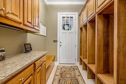 Separate mudroom entrance with custom lockers and built-ins. Storage bench for shoes.