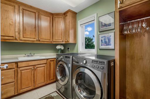 Last up on the upper level, the exceptional laundry room with more custom built-ins for storage.