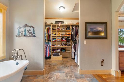 walk in closet with custom shelving in master bedroom