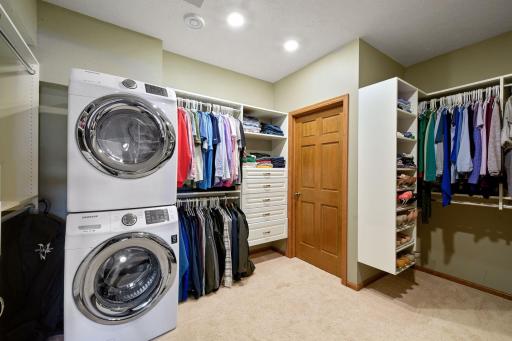 Master Closet Envy!! Showcase your clothing rather than simply storing it. And laundry units to boot!