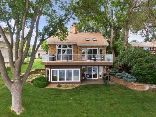 Outdoor spaces are where people go to relax, unwind, entertain, and play with their pets and families. Outdoor spaces are where memories are made, enjoy this well manicured yard with a gradual elevation down to the lake