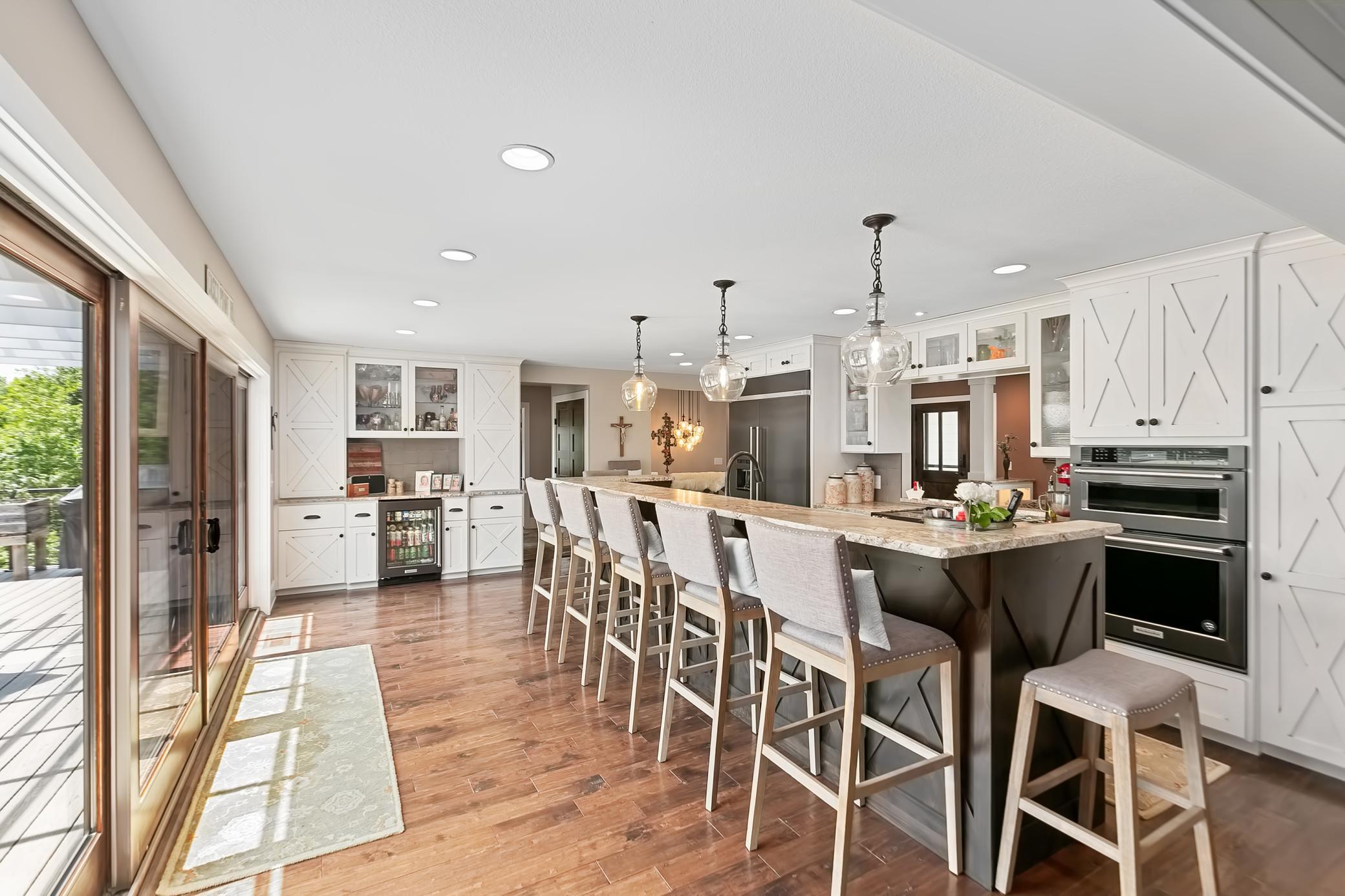 Spacious kitchen also has a bar area, beautiful built-ins and a beverage refrigerator.