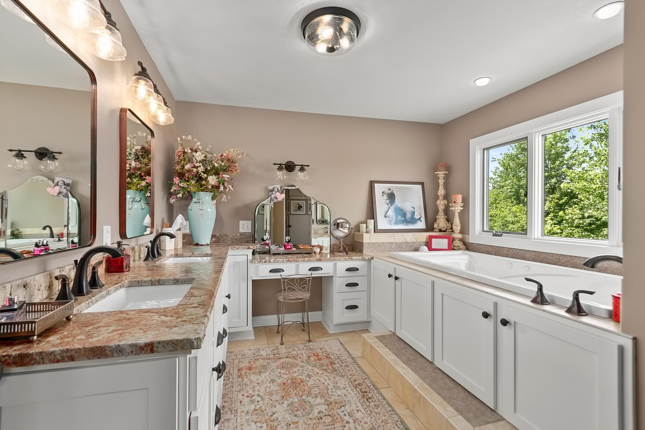 Updated owners bath with dual sinks, soaking tub and separate shower.