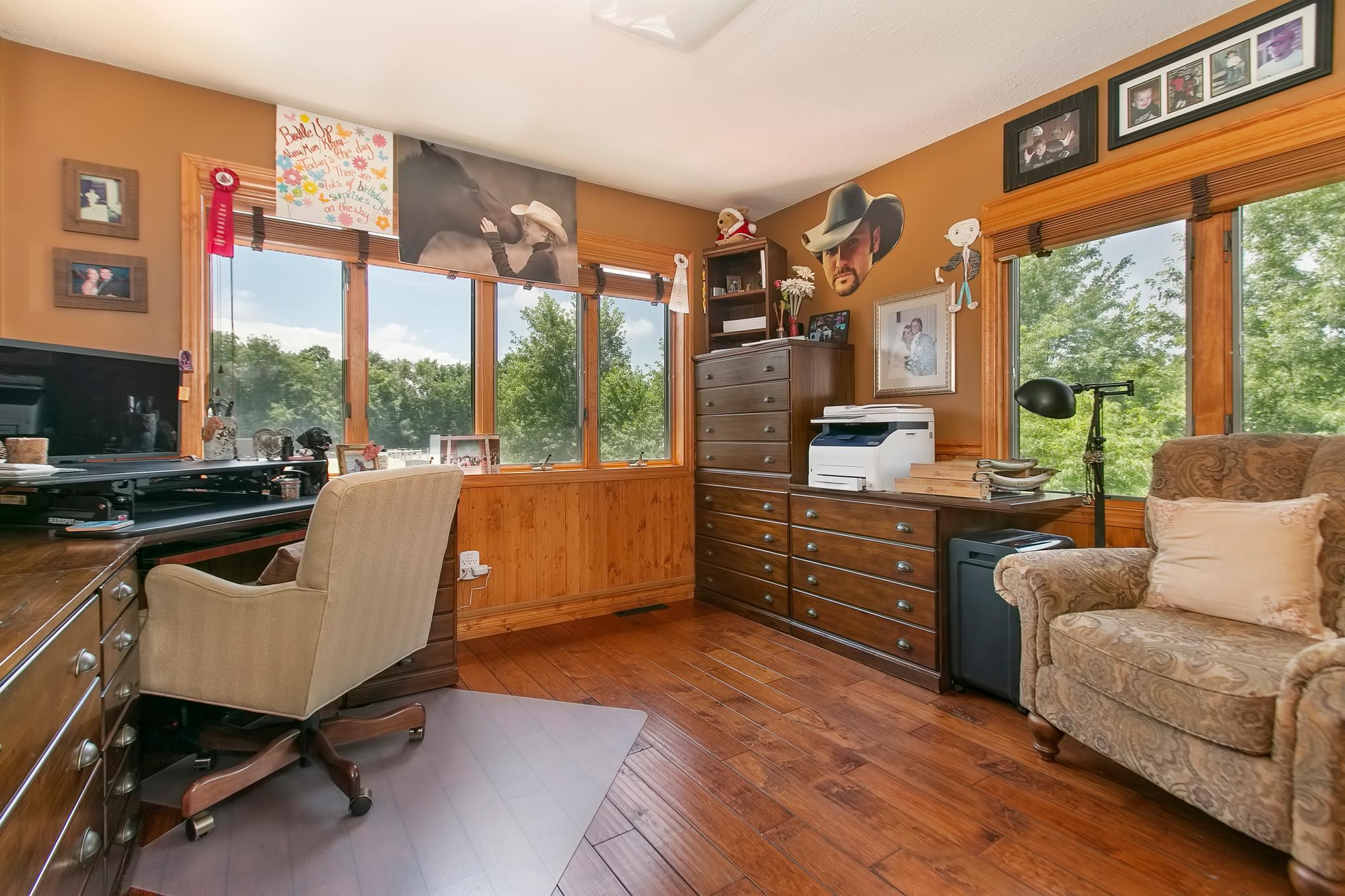 Current owners use this main level bedroom as their office. Private views of the pastures and also the pool.