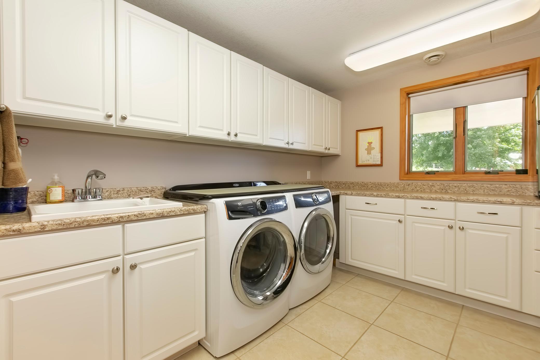 An abundance of cabinetry in the laundry room.