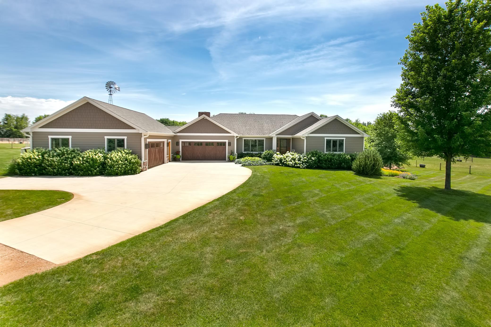 Sprawling rambler built in 2007 with a heated oversized four car garage with office space as well.