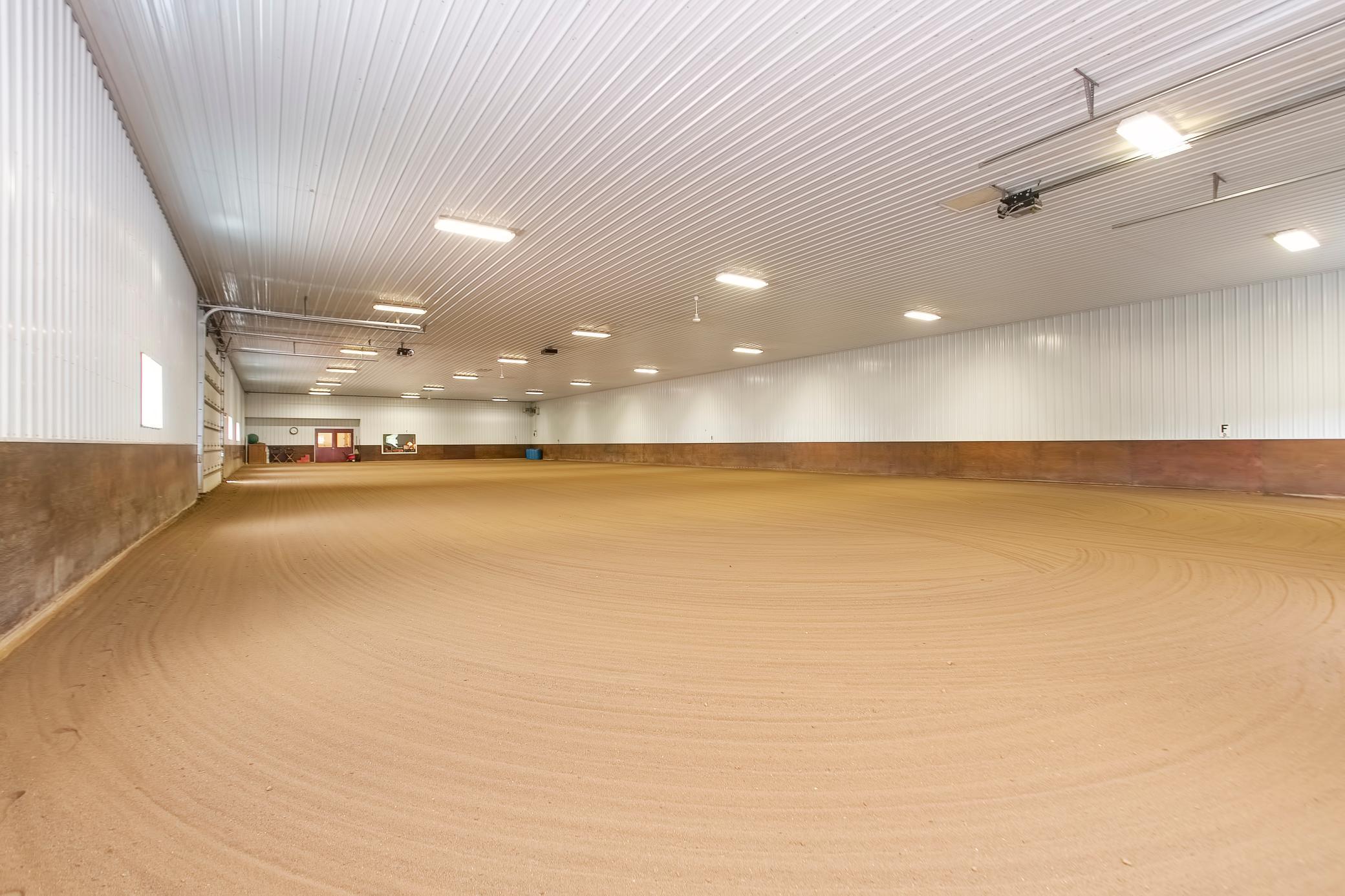 The indoor arena is approximately 66 X 165. It is heated and insulated and has sand footing.