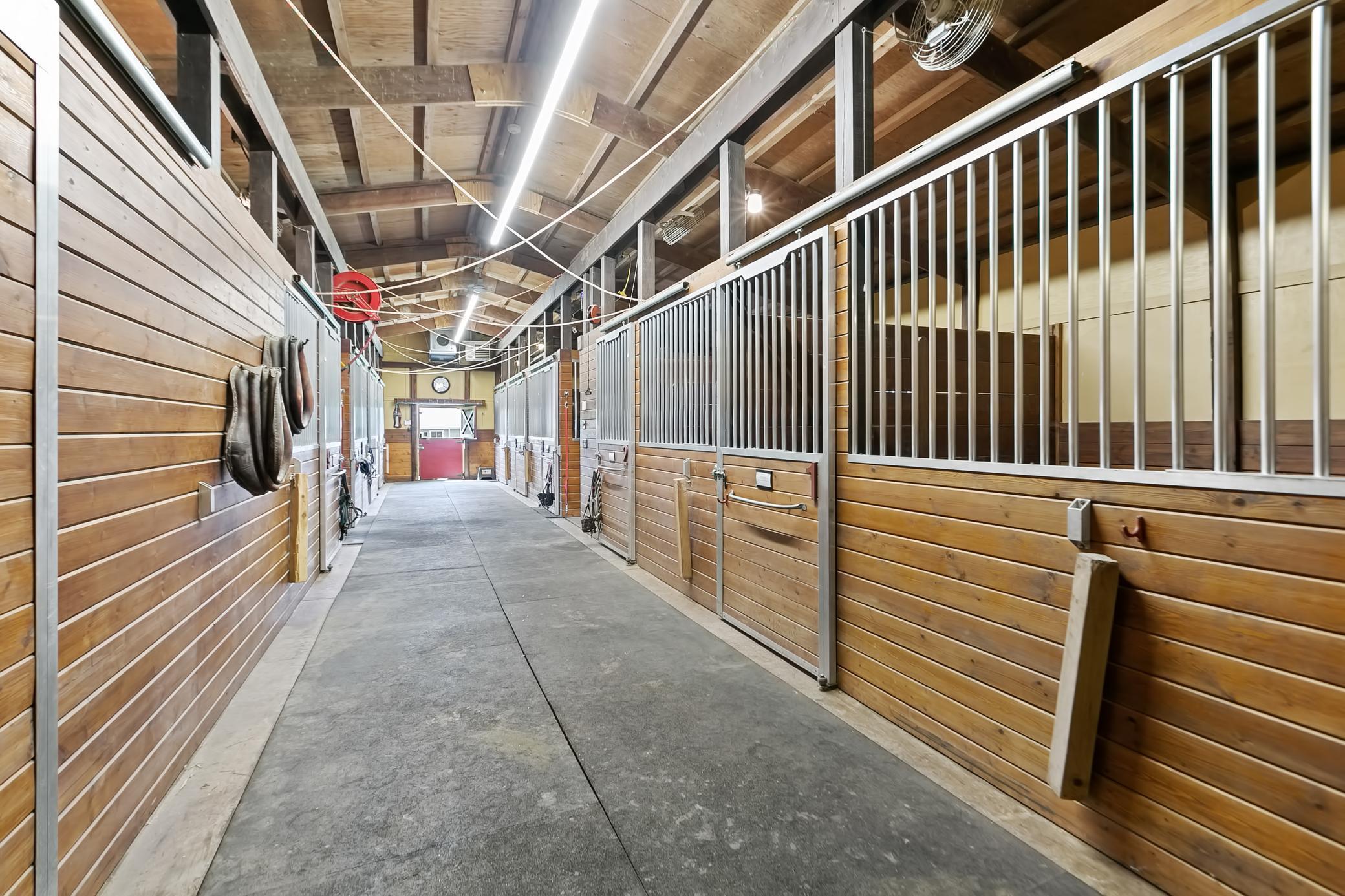 The heated barn has 9 horse stalls, with one containing a lift for an injured or recovering horse.