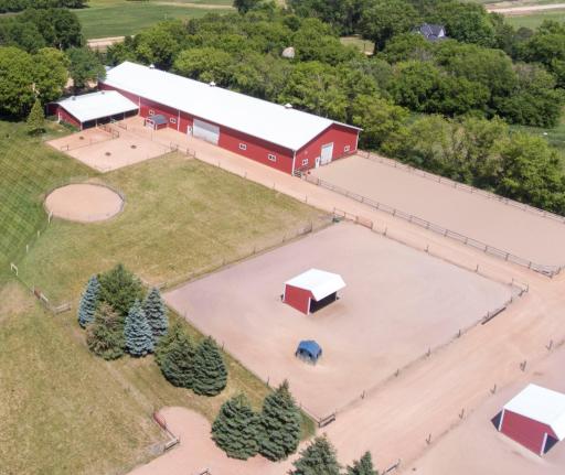Arial of the property focussing on the barn and riding arenas.