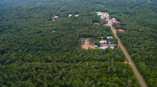 Drone image shows the convenient proximity to downtown Webb Lake. Walk to town and enjoy music on the deck of a local bar/eatery, grab a few groceries/gas at Main store, or hop on your recreational vehicles and enjoy the nearby trails from parcel.