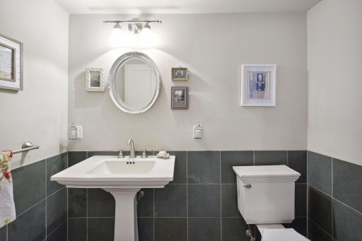 The main floor guest powder room with cabinetry for storing essentials.
The washer and dryer are housed within the closet adjacent from the powder room.