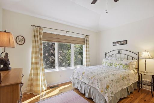 The 2nd upper level bedroom offers a gentle vault ceiling, ceiling fan, walk-in closet and an en-suite, fully roughed in bathroom, ready for your finishing touches. You can also enjoy lake views from this room.