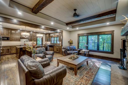 The home is equipped w/ADT security & features sprawling custom hardwood flooring & trim, exposed stone, custom built-ins, & accent lighting throughout!