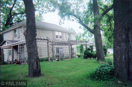 Photo shows home approx. 8 years ago. Pergola provided shade for a wonderful shade garden