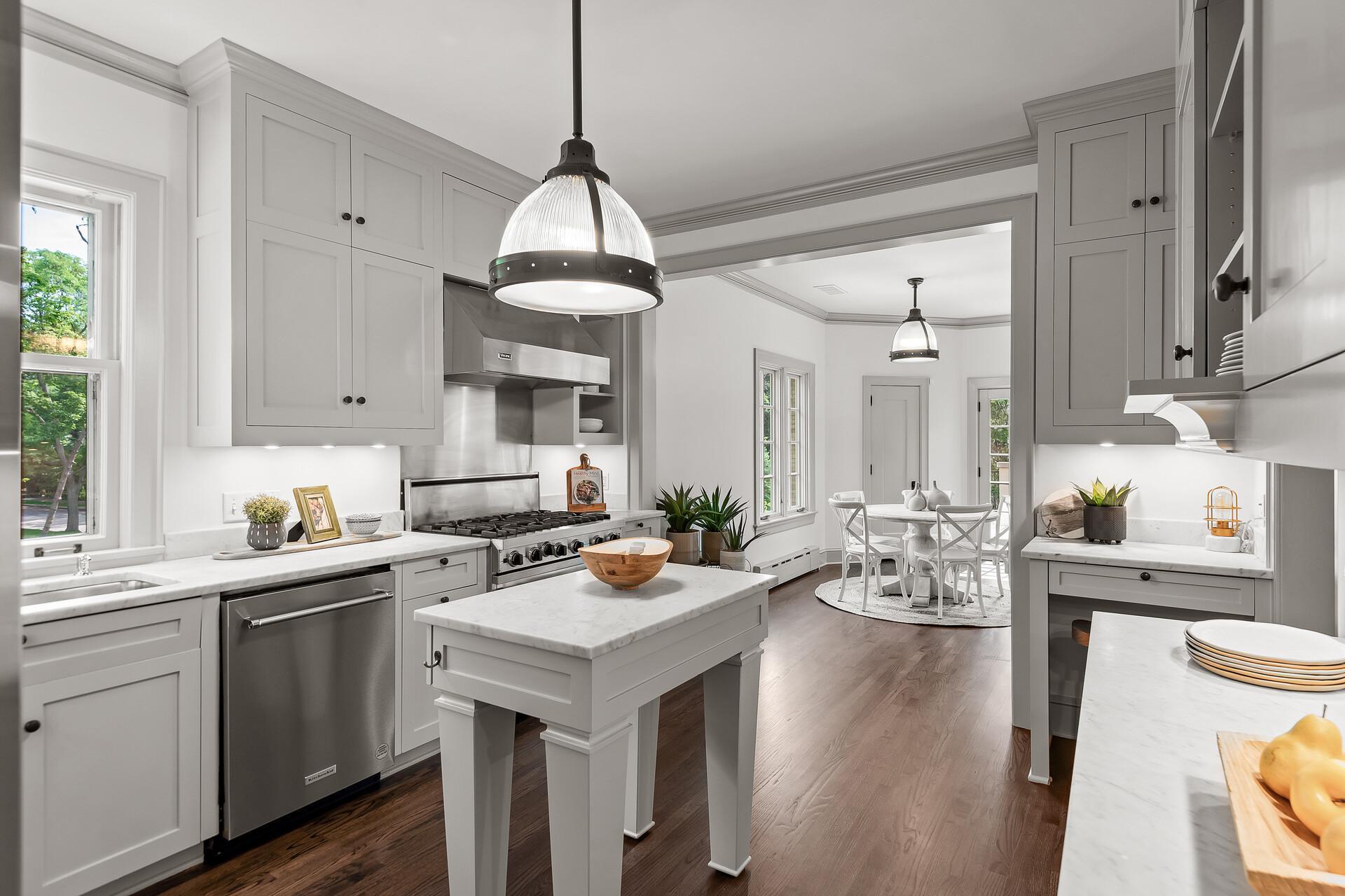 The gourmet kitchen boasts high-end Viking appliances, marble countertops, and a wealth of storage.