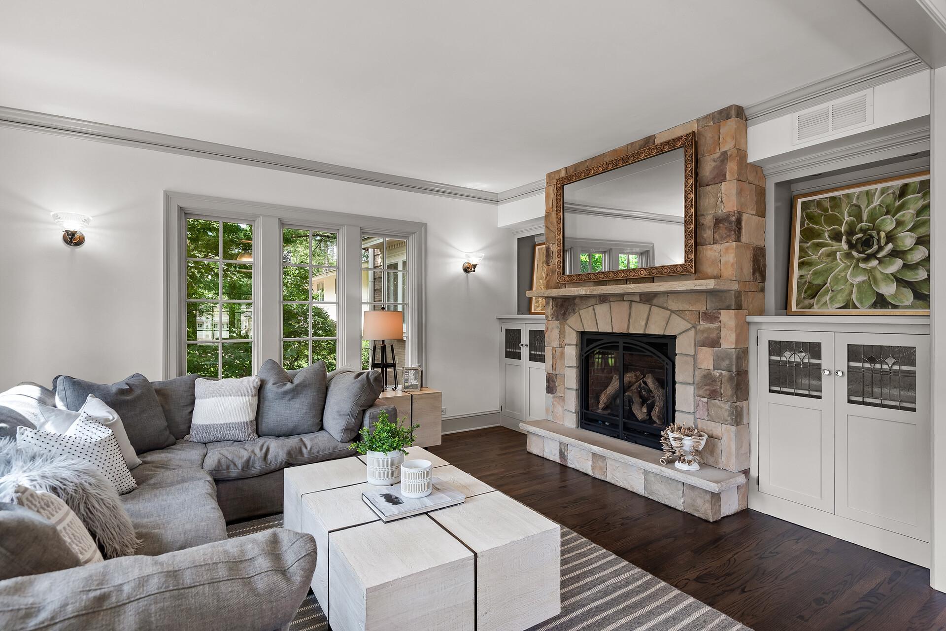 Wonderful family room with several oversized windows, and a gas fireplace surrounded in top to bottom stone and flanked with built-ins.