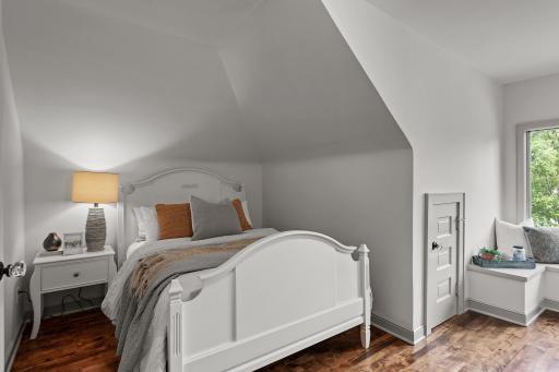 Charming bedroom with hardwood floors, window bench seating with a view of Lake Harriet, and dual closets including a cedar closet!