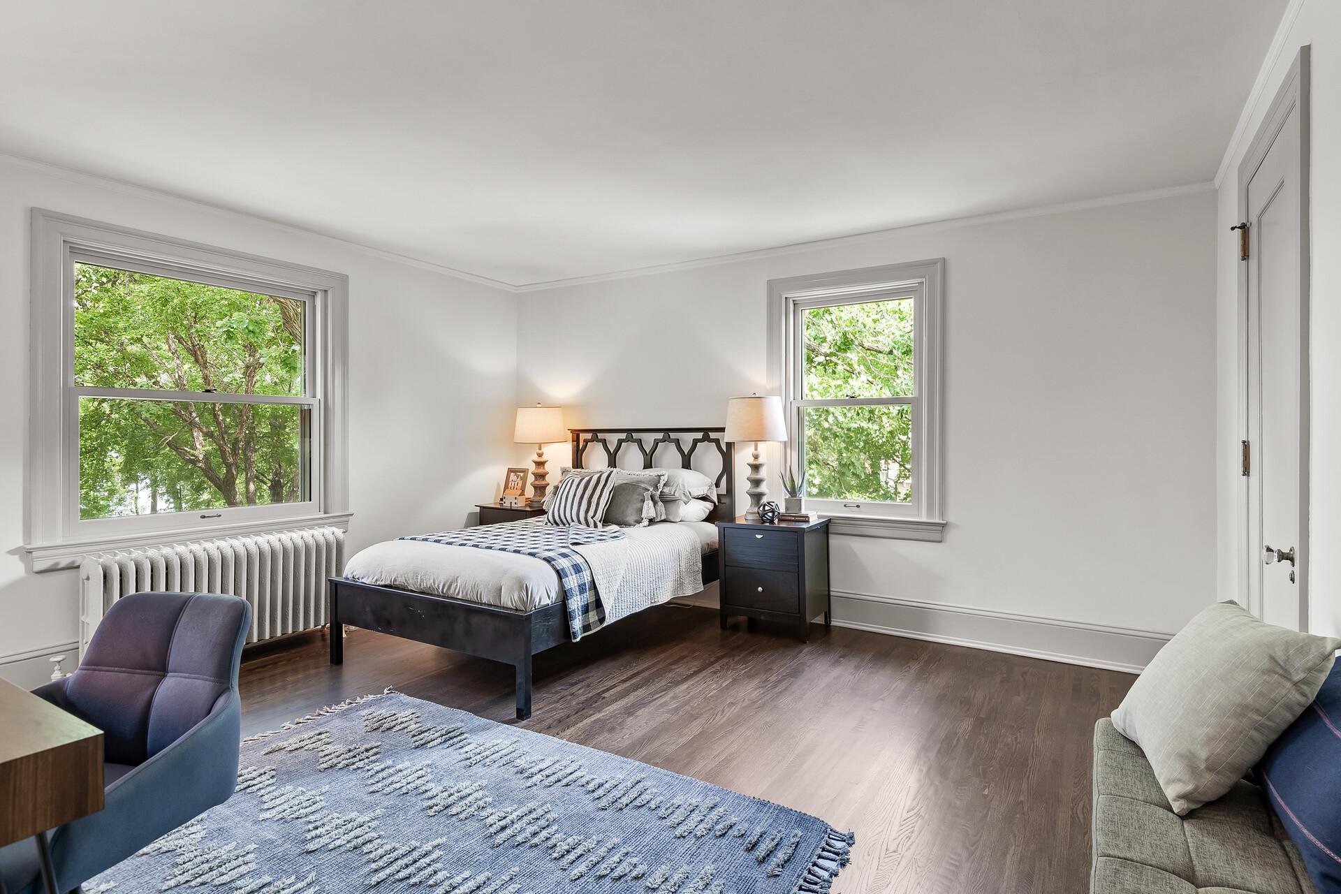 Three spacious bedrooms on the upper level all with hardwood floors. This one has a lakeview and includes access to the three-quarter walk-through bathroom.