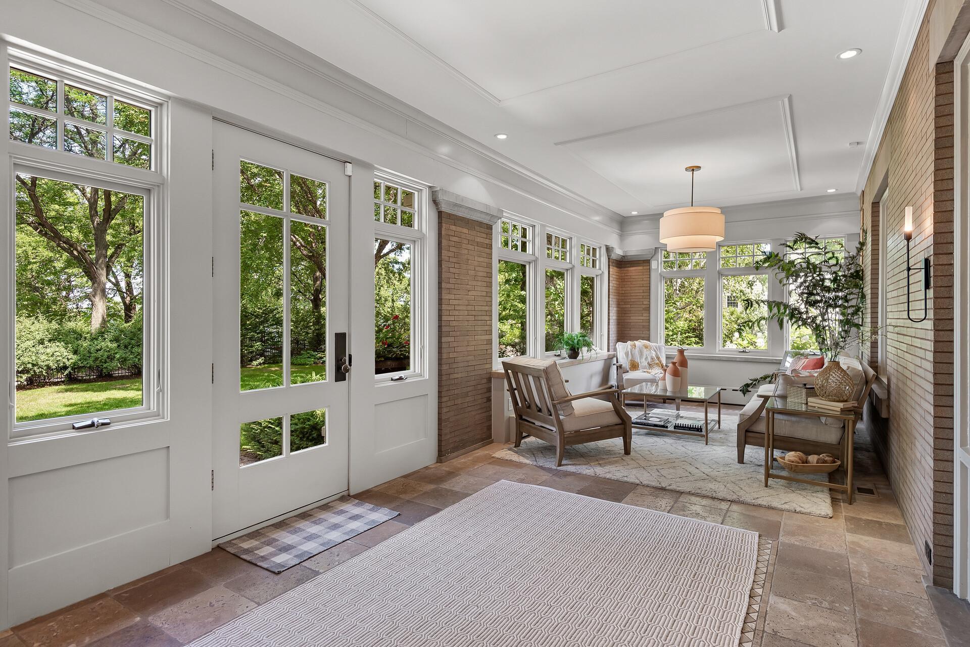 Wonderful four-season porch welcomes you to this incredible estate. Custom stone floor, stone and brick accents, and wall to wall windows with a view of Lake Harriet!