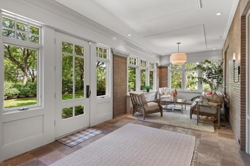Wonderful four-season porch welcomes you to this incredible estate. Custom stone floor, stone and brick accents, and wall to wall windows with a view of Lake Harriet!