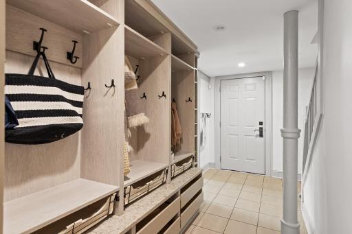 Custom mudroom with built-in lockers, drawers, hooks, and cubbies - so convenient! Access to the attached 2-car heated garage with electric car charger.