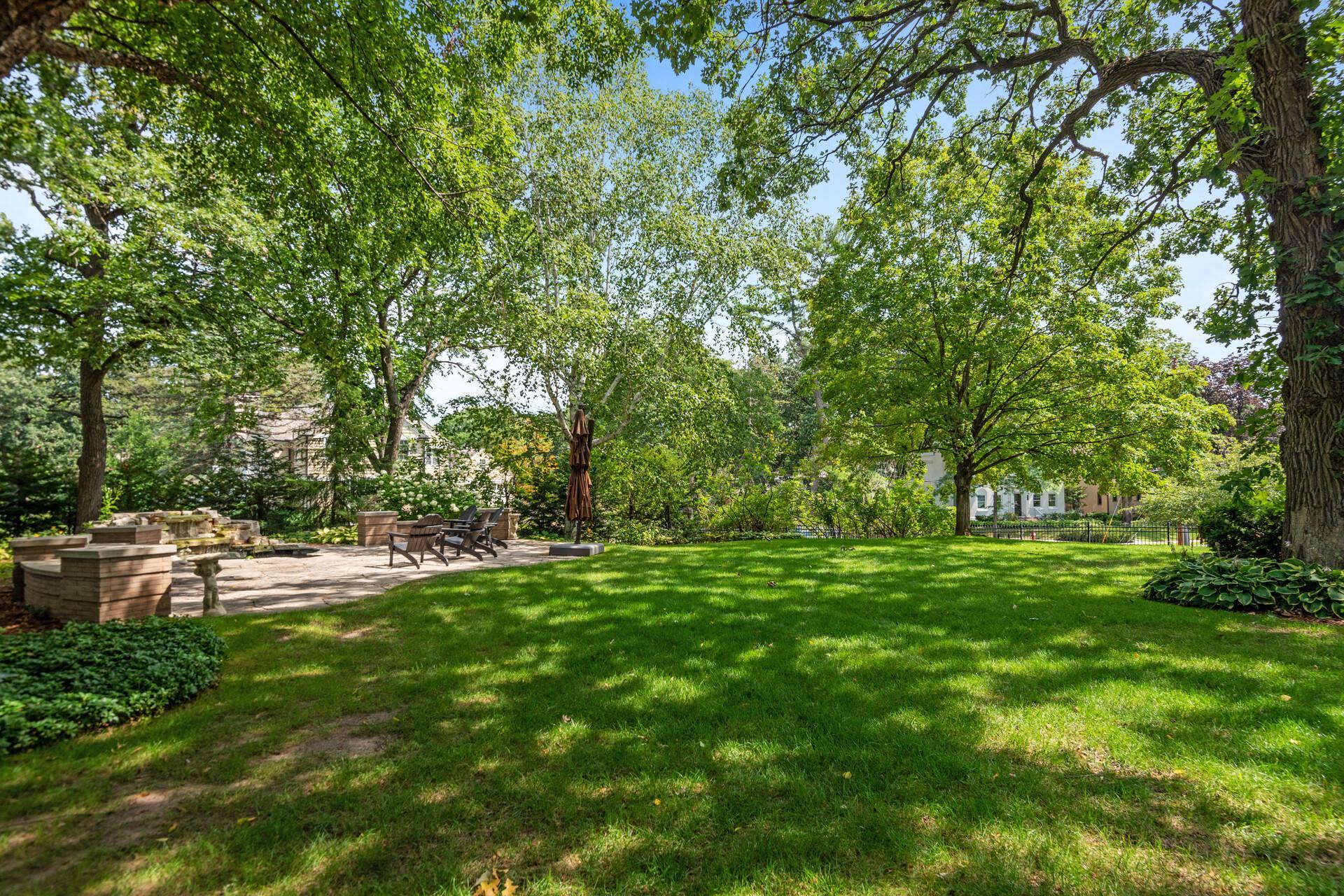 Spacious yard, fully fenced, with in-ground irrigation system, beautiful landscaping with lush perennials, mature trees AND lake views!