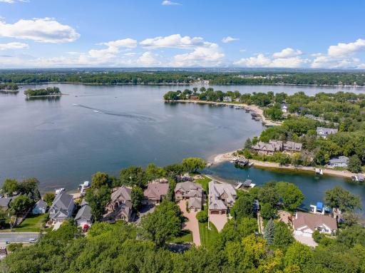 A true Storybook setting for this walkout 2 story on Lower Prior Lake with over 1/2 acre of gently sloping lakefront and picturesque landscape. This sanctuary shaped haven is lined with mature trees that engage the sunset filled skies.