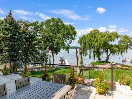 Glass panels allow for seamless lake views while enjoying the the generously sized decks and patio