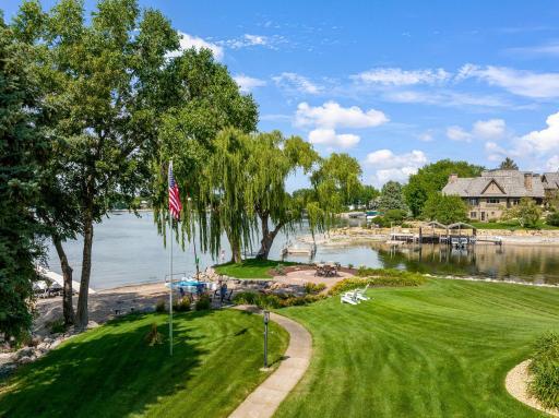 Expansive lush lawn separates home from the lakeshore