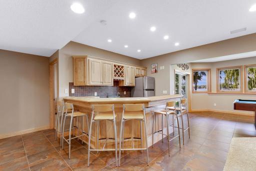 Raised countertop wraps around bar and can accommodate multiple stools