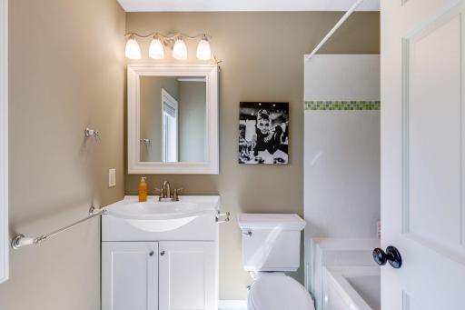 3rd Bedroom's private Full Bathroom features subway tile surround with decorative glass tile accents and ceramic tile flooring