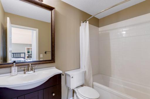 2nd Bedroom's private Full Bathroom features classic subway tile tub surround and mosaic tile flooring