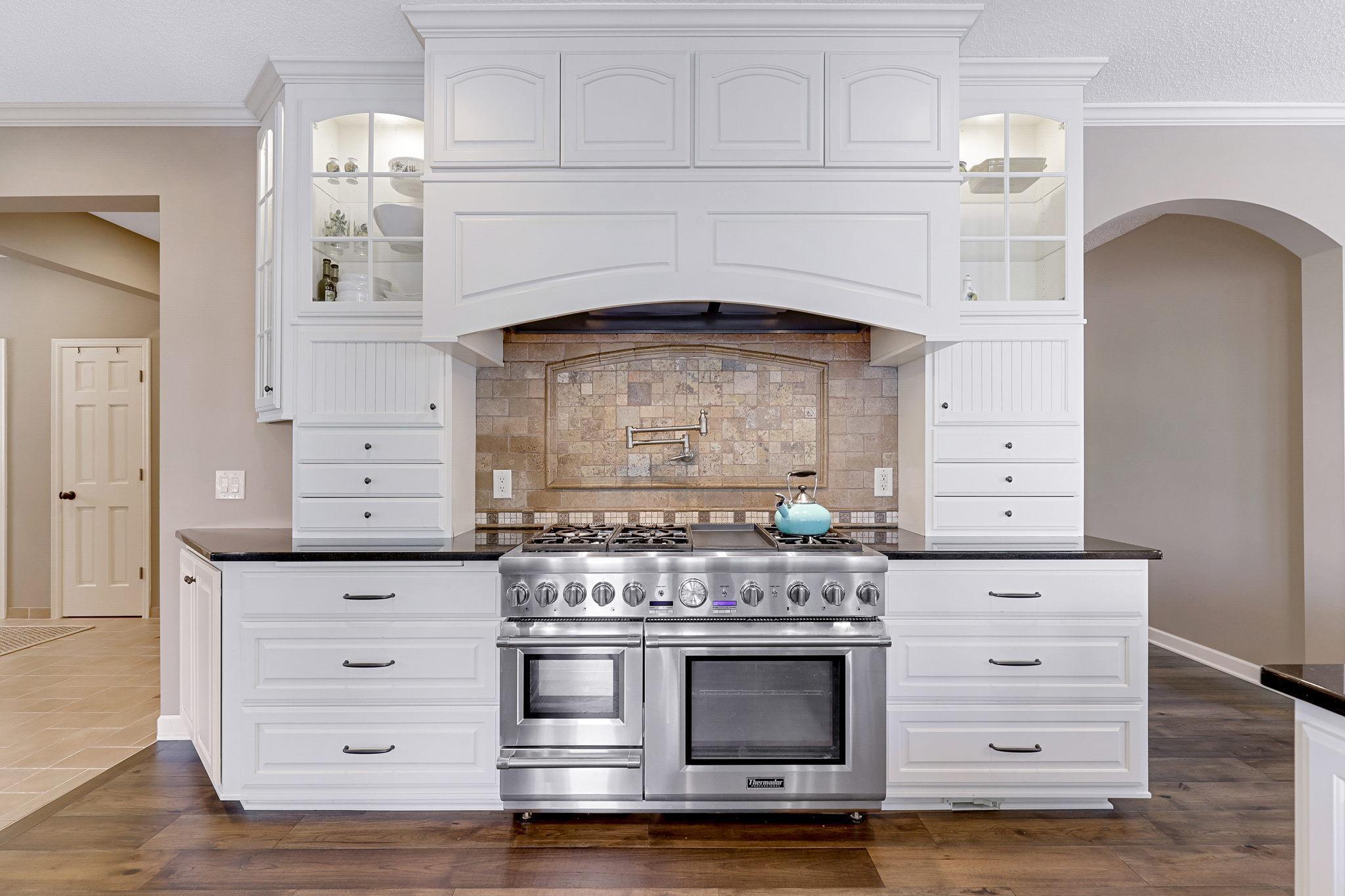 Professional grade appliances include a dual fuel 48” Thermador range w/ cabinet paneled vent, cabinet paneled refrigerator, cabinet paneled Jenn-Air dual refrigerator and freezer drawers built-in microwave and dishwasher