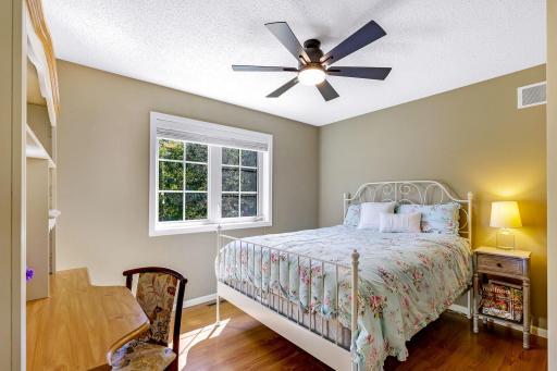 Upper level 4th Bedroom features laminate flooring and ceiling fan