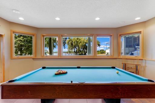 Lower level Amusement Room with full glass patio door and access to the lower level patio